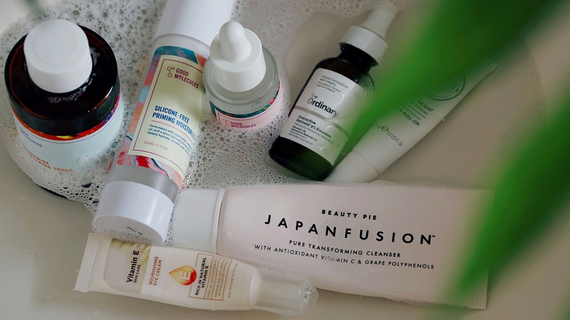 an array of skincare products in the sink