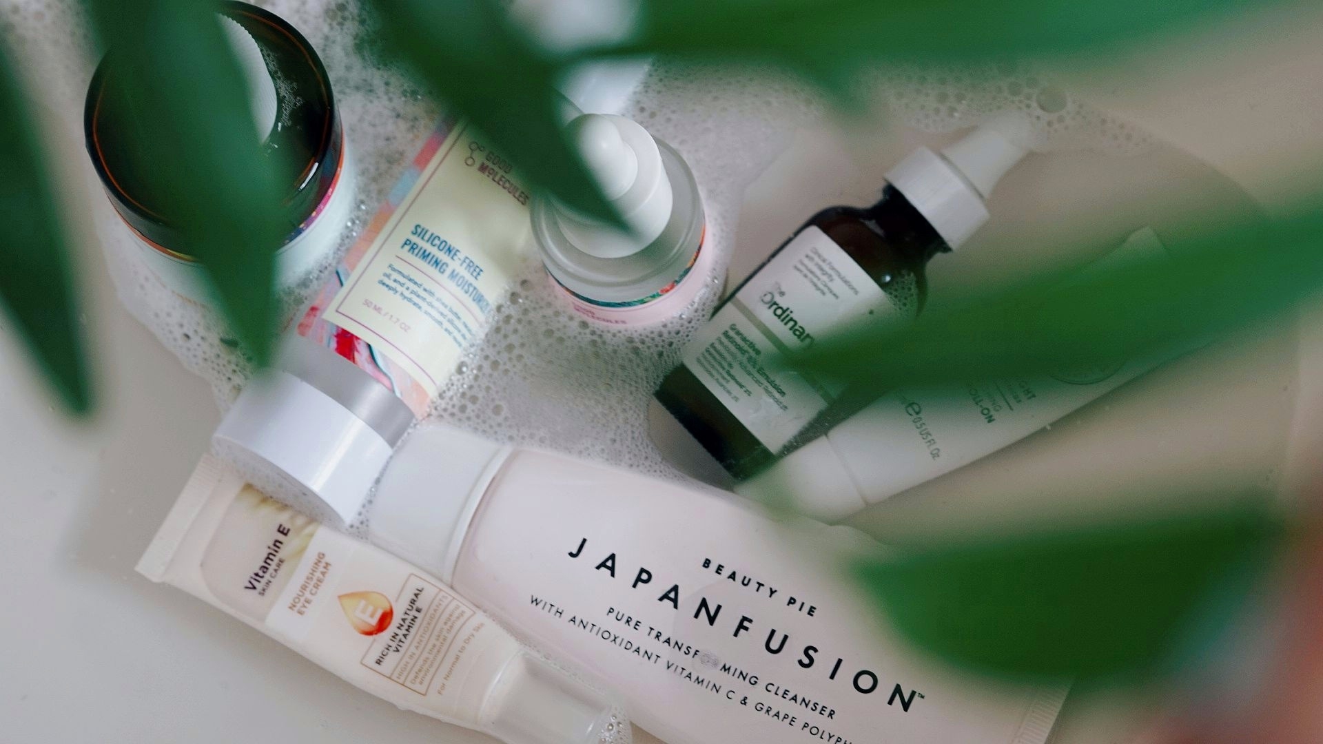an array of skincare products in the sink