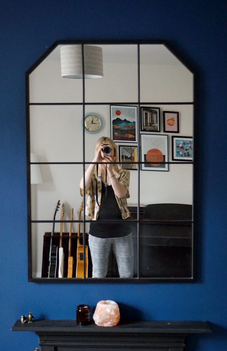 Outfit photo: Amy is taking a mirror selfie, wearing check leggings, a black vest top and a floral short sleeved yellow blouse
