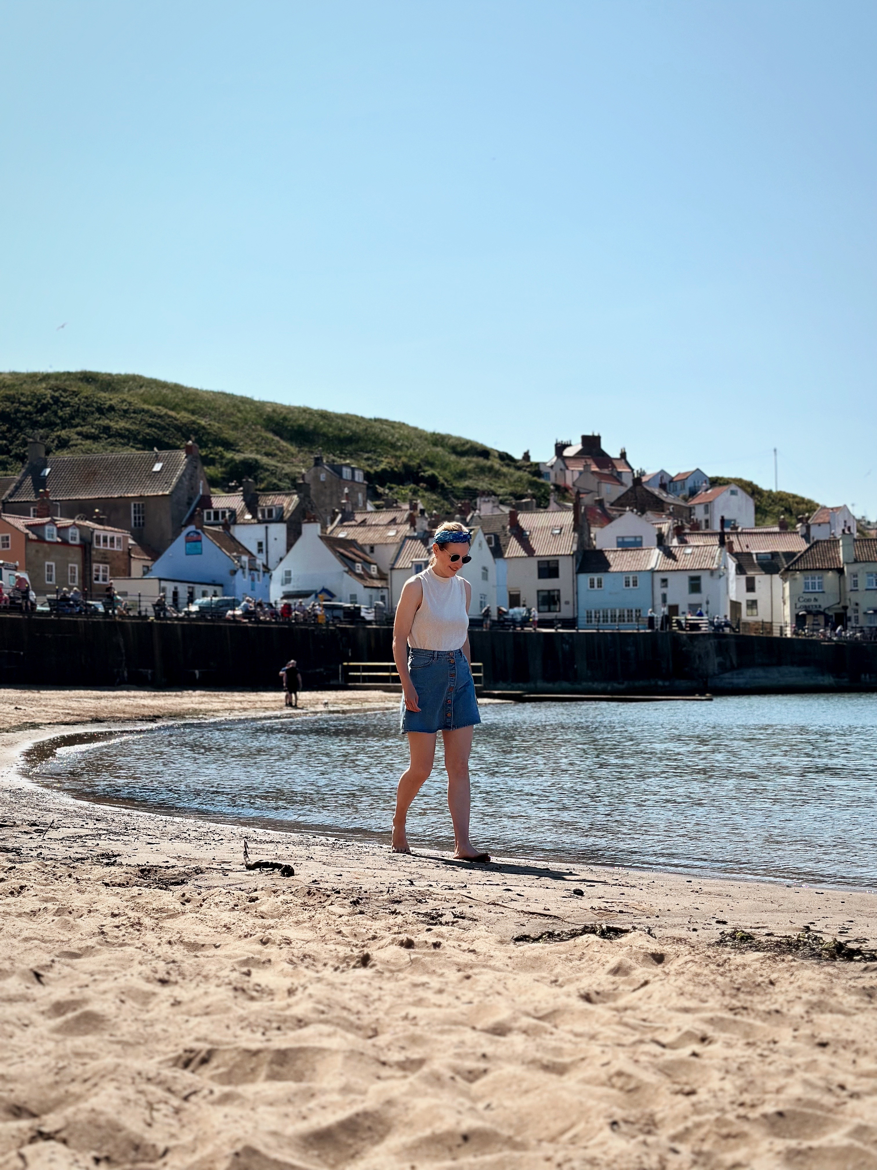 a woman walking along the beach