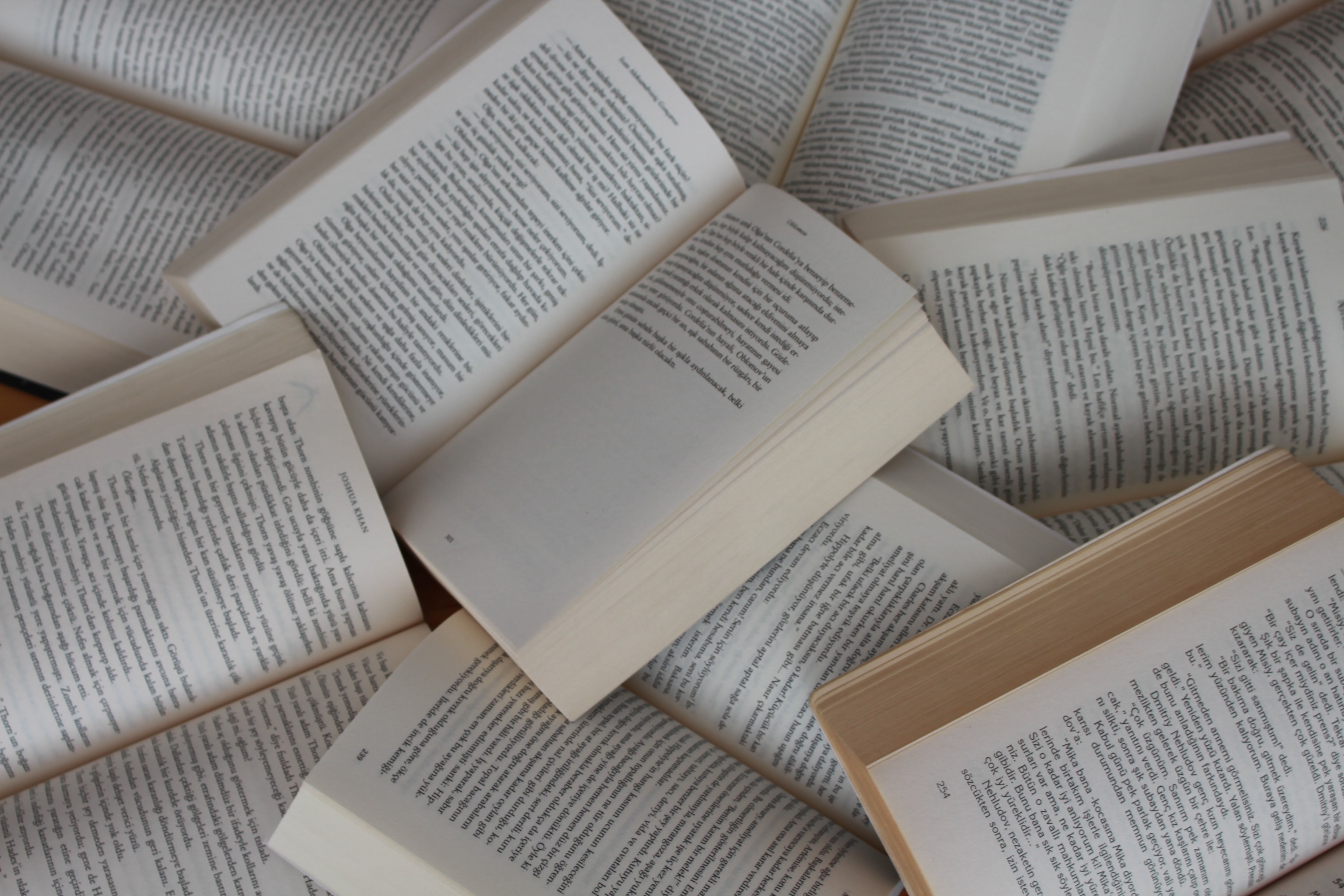 Various open books spread across each other.