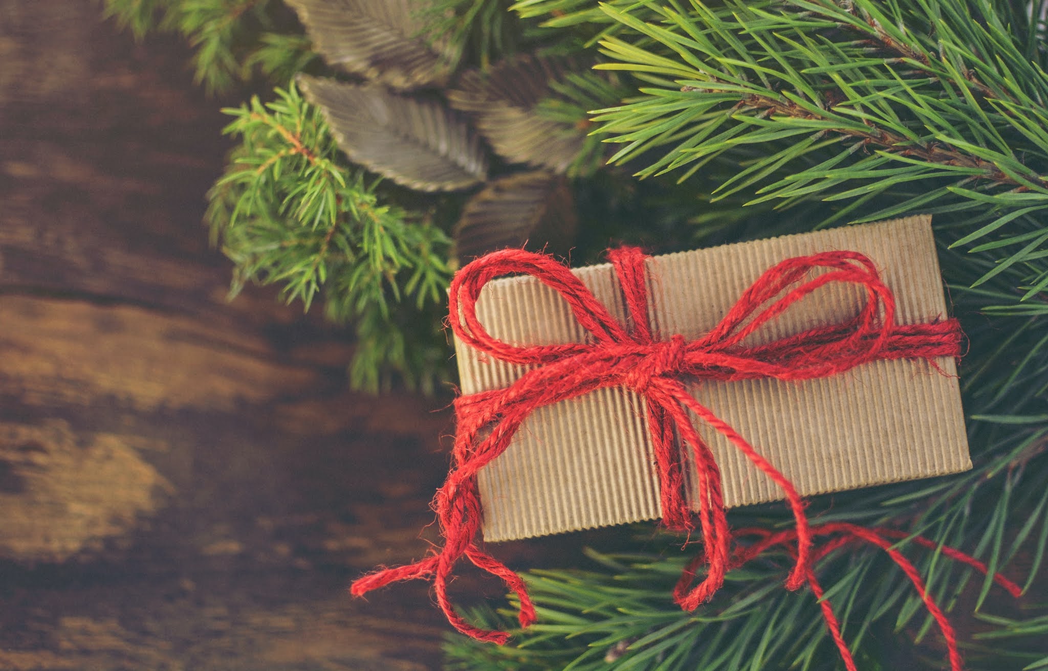 wrapped present in brown paper tied with red string