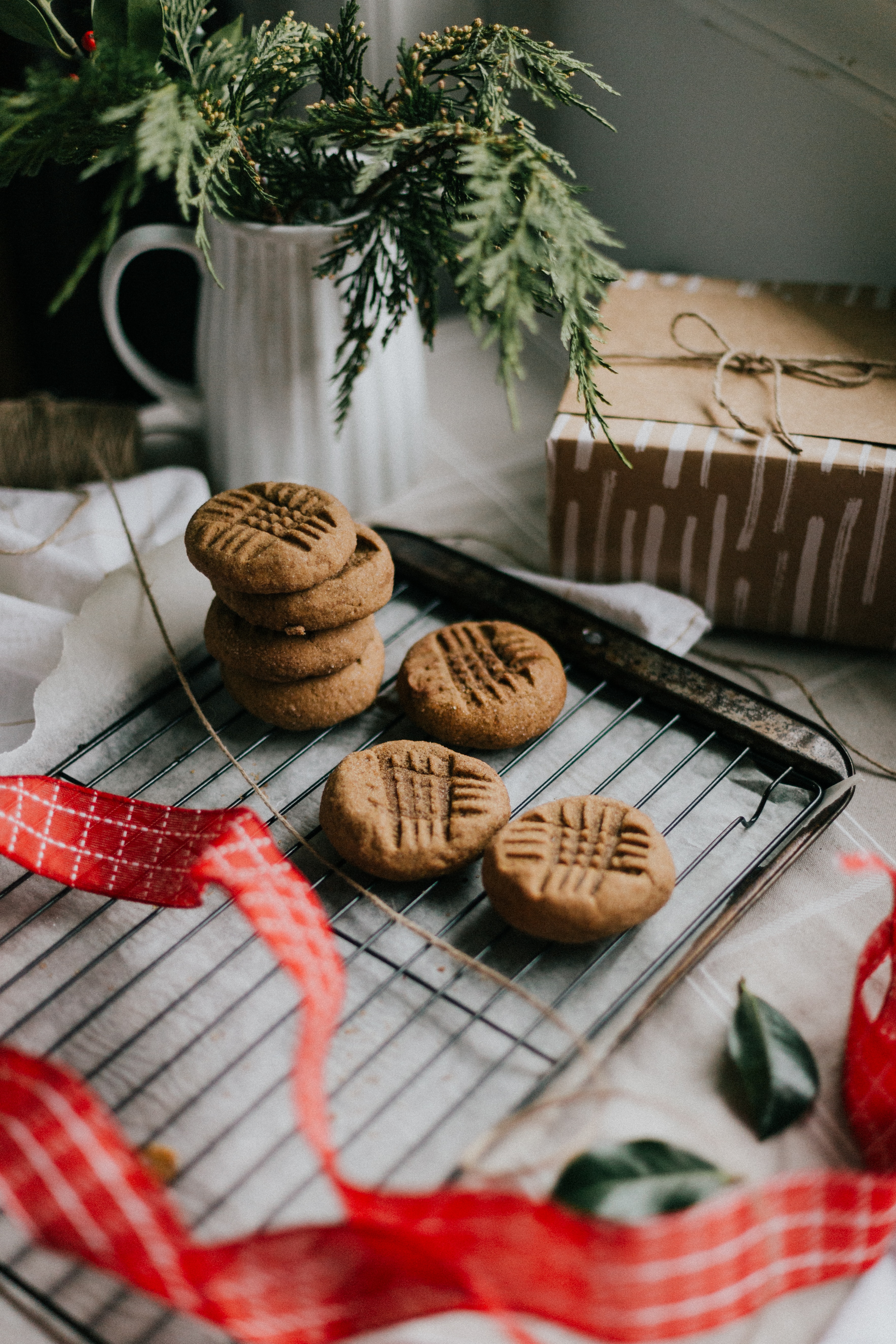 chunky cookies flatlay surrounded by wrapped christmas presents and kitchen paraphenalia
