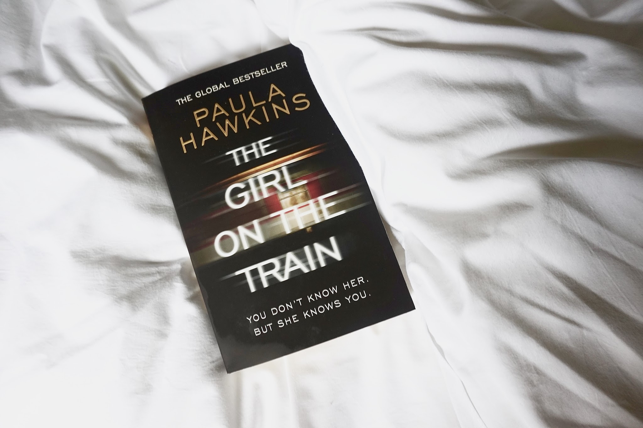 The Girl on the Train book on white bed