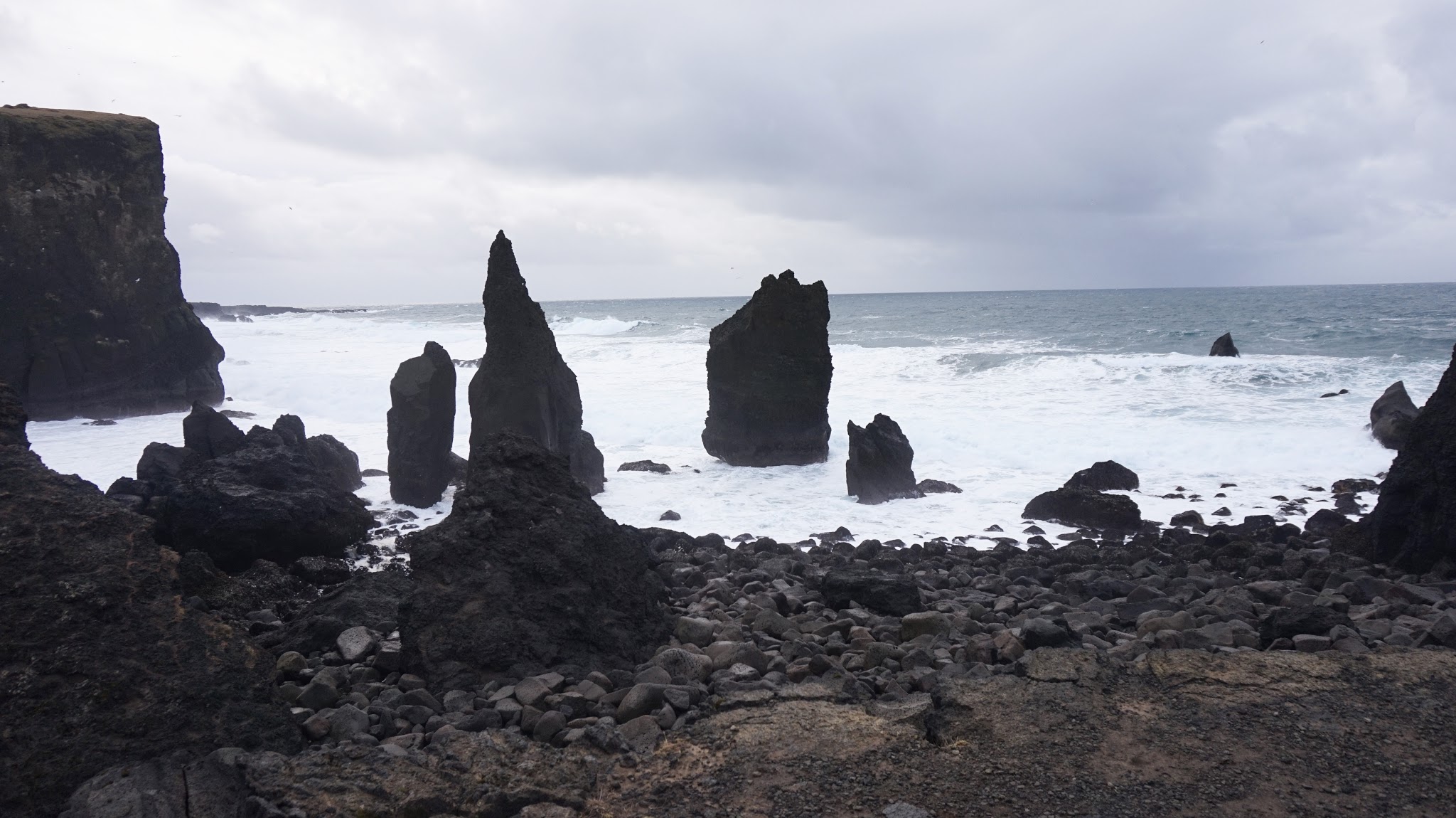 spiky black rocks sticking out of the sea