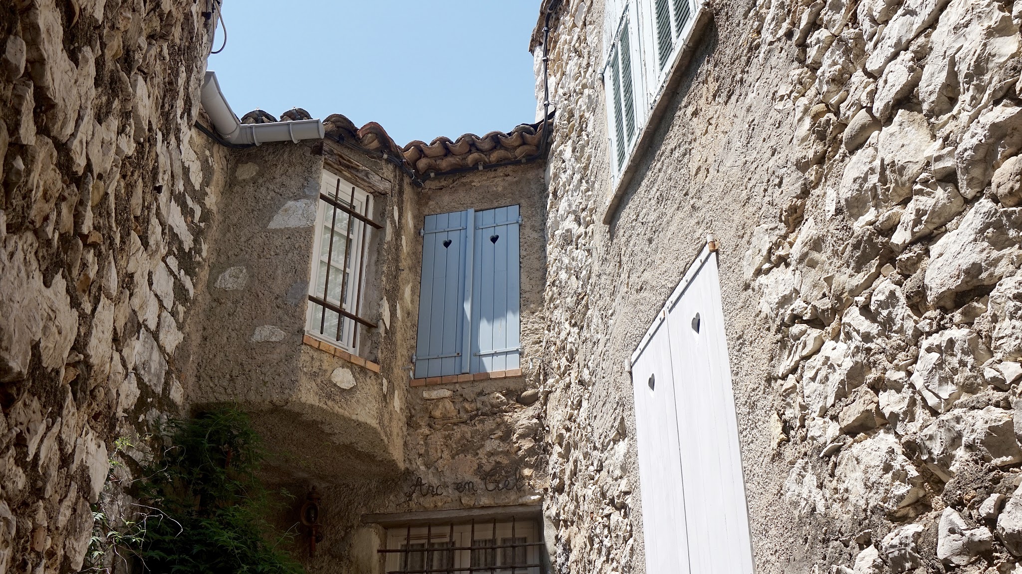 stone walls with wooden window shutters closed, heart shapes cut into wood