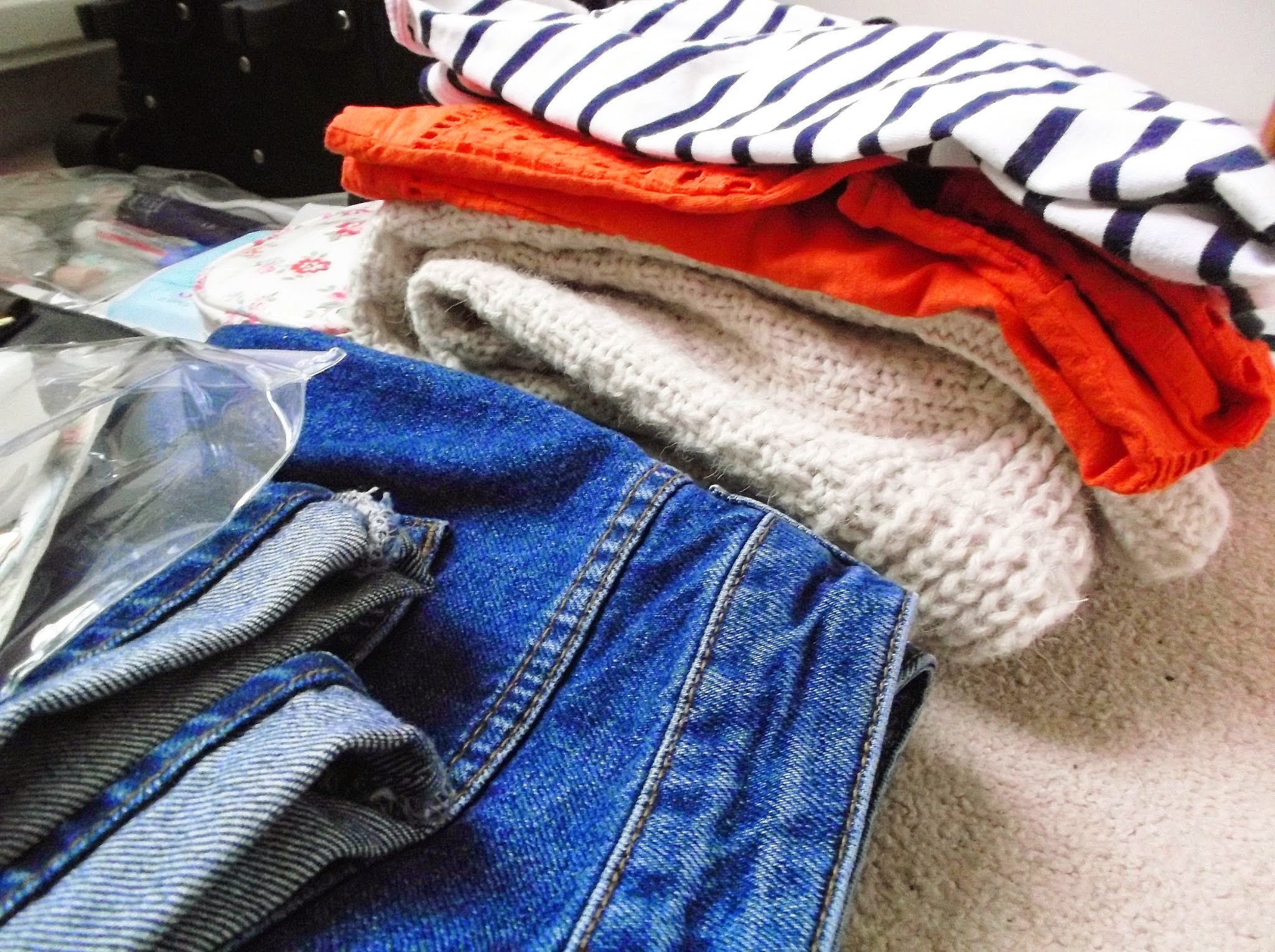 Clothes and toiletries ready to be packed into a suitcase