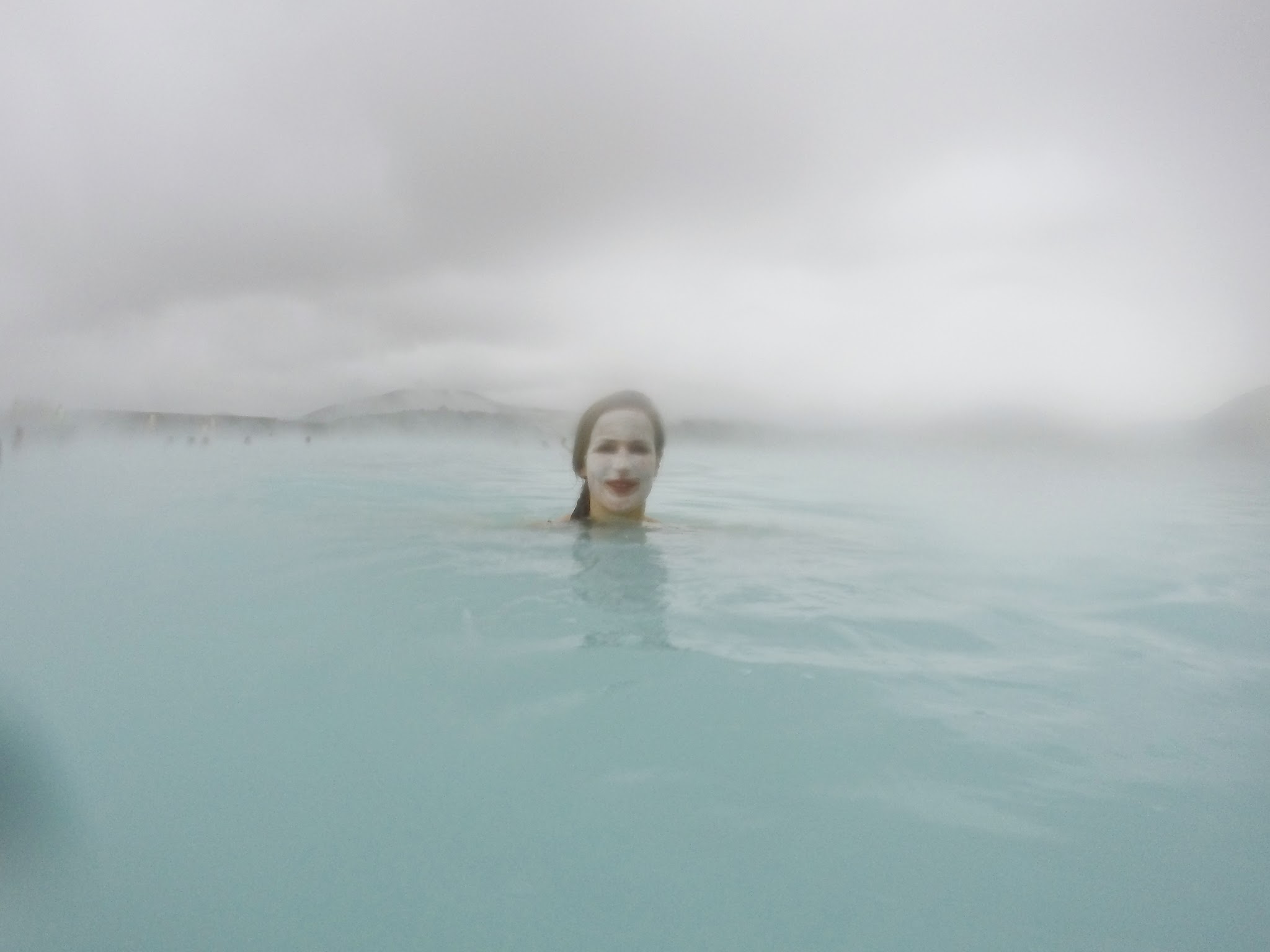 fisheye lens, woman with face mask on in water