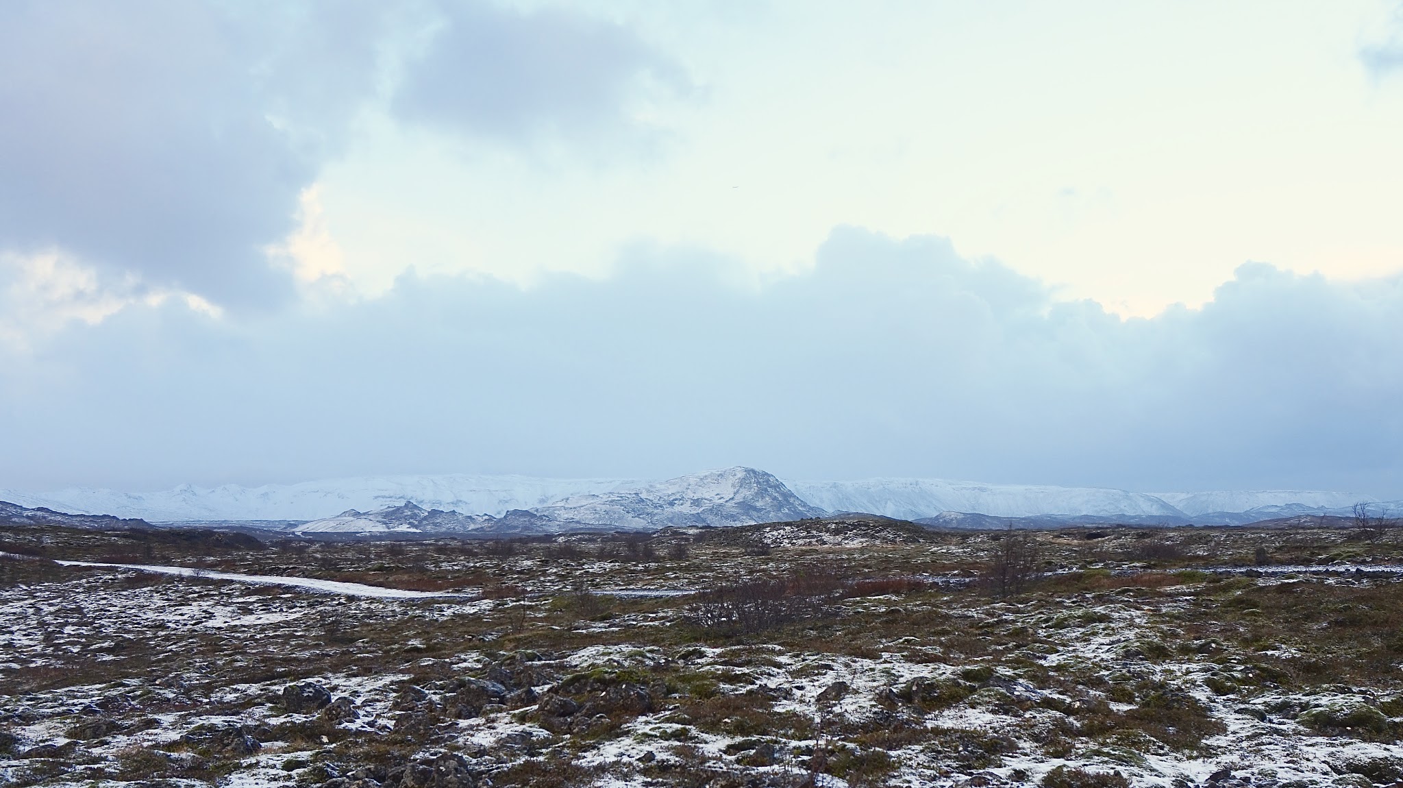 a snowy, cloudy, moody scene in Iceland